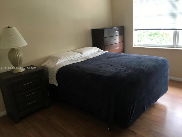 bedroom with hardwood / wood-style floors