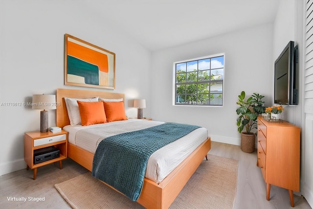 bedroom featuring baseboards and light wood-style floors