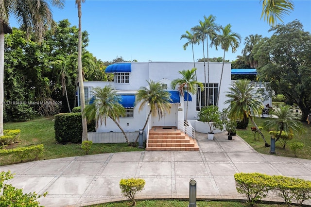 mediterranean / spanish-style house featuring a front yard