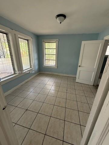 spare room featuring light tile patterned floors