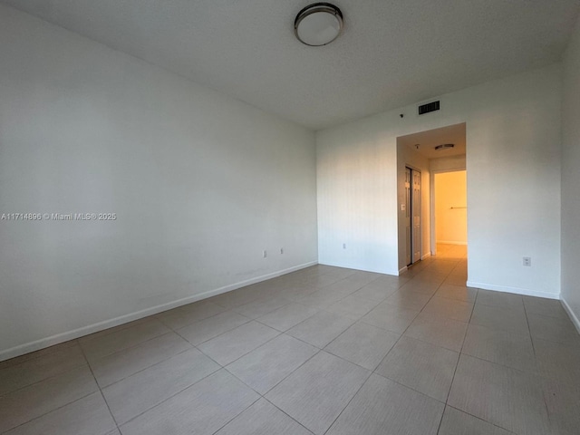 unfurnished room featuring light tile patterned floors