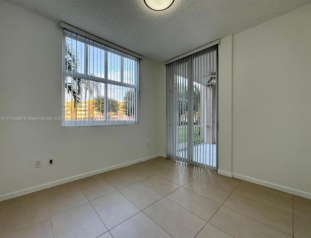 unfurnished room with a textured ceiling