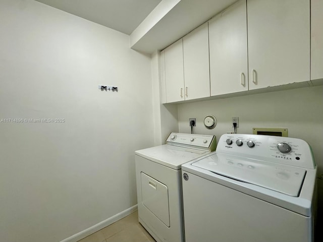 washroom with cabinets, separate washer and dryer, and light tile patterned floors