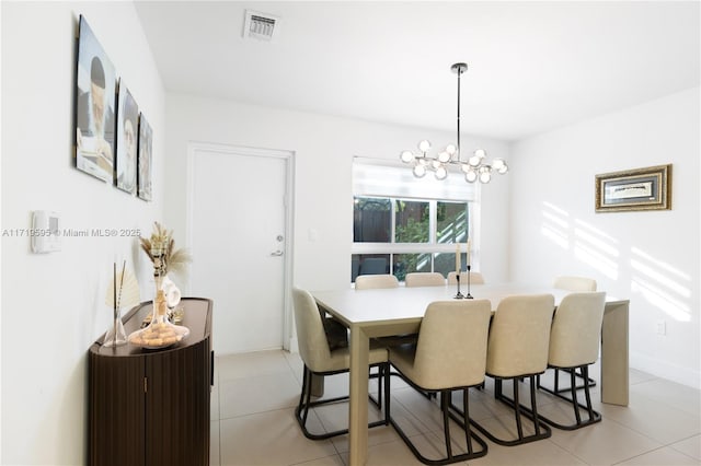 dining area featuring light tile patterned floors and a chandelier