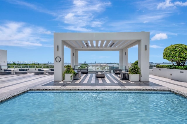 view of pool with a pergola, a patio, and an outdoor hangout area