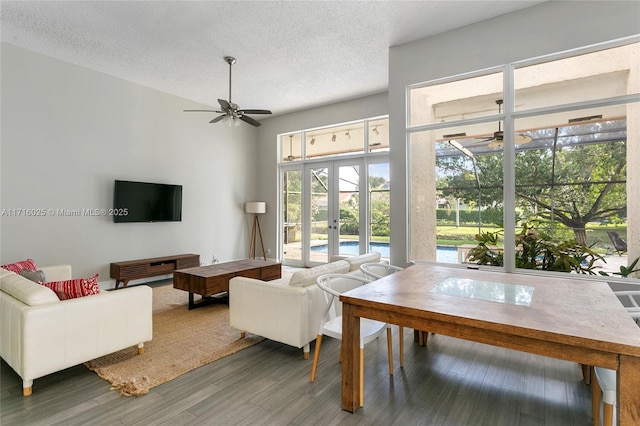 living room featuring a textured ceiling, ceiling fan, french doors, and dark hardwood / wood-style floors