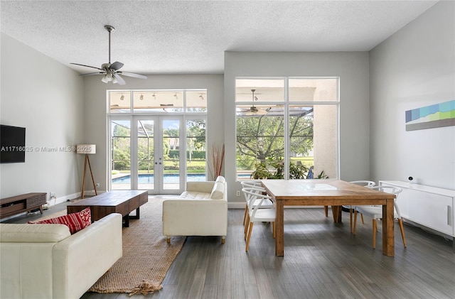 living room with french doors, dark hardwood / wood-style flooring, a textured ceiling, and ceiling fan