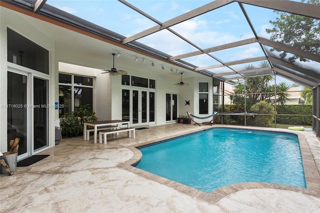 view of pool with a lanai, a patio area, and ceiling fan