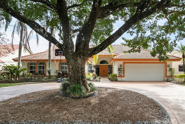 mediterranean / spanish house with a garage