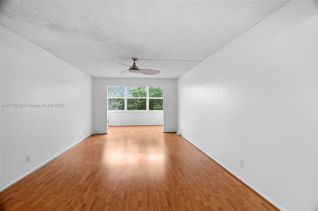 6700 Cypress Rd Unit 412, Plantation, FL 33317 - unfurnished room with ceiling fan, wood finished floors, a textured ceiling, and baseboards