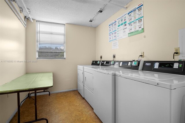 6700 Cypress Rd Unit 412, Plantation, FL 33317 - community laundry with washer and clothes dryer, light flooring, baseboards, and a textured ceiling