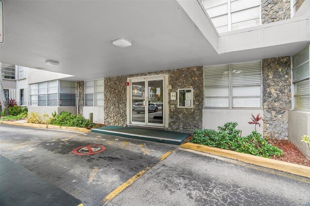 6700 Cypress Rd Unit 412, Plantation, FL 33317 - doorway to property with stone siding and uncovered parking
