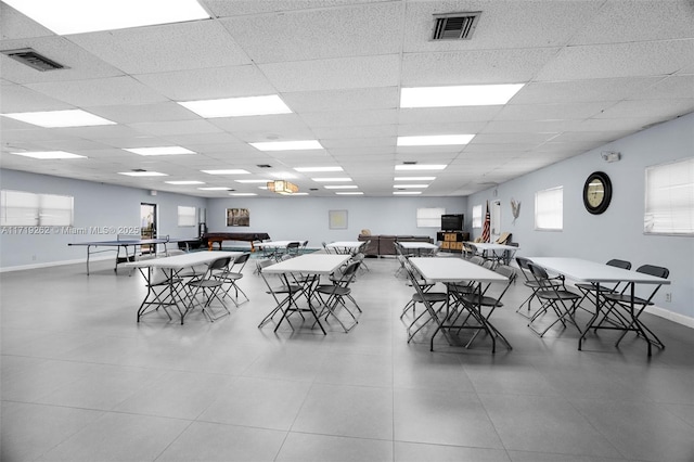 dining space featuring a drop ceiling and a wealth of natural light