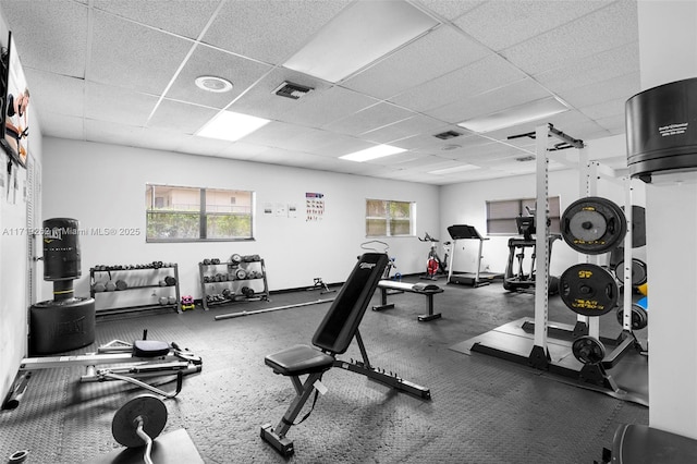 exercise room featuring a paneled ceiling