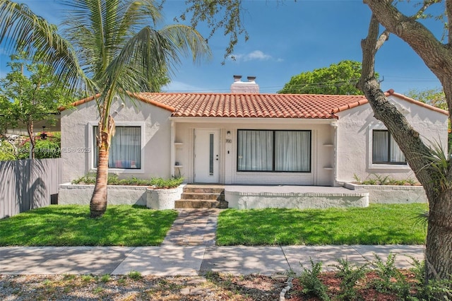 mediterranean / spanish home with a front lawn and covered porch