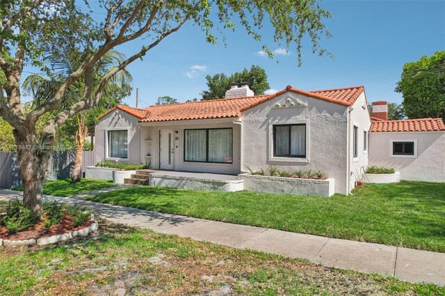 mediterranean / spanish house featuring a front yard