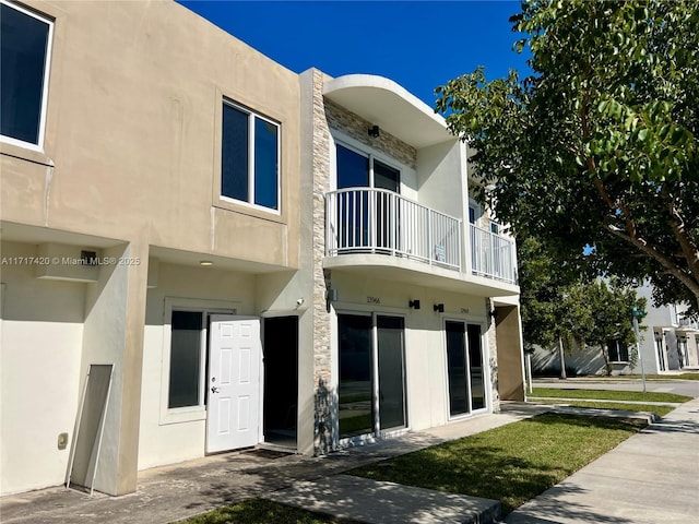 back of house with a balcony