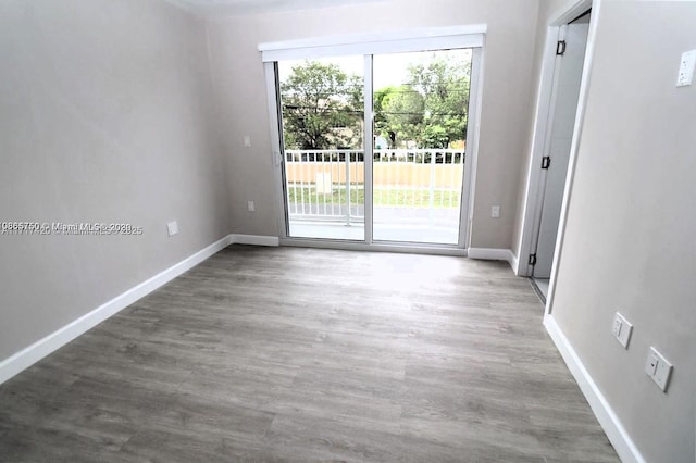 empty room with hardwood / wood-style flooring