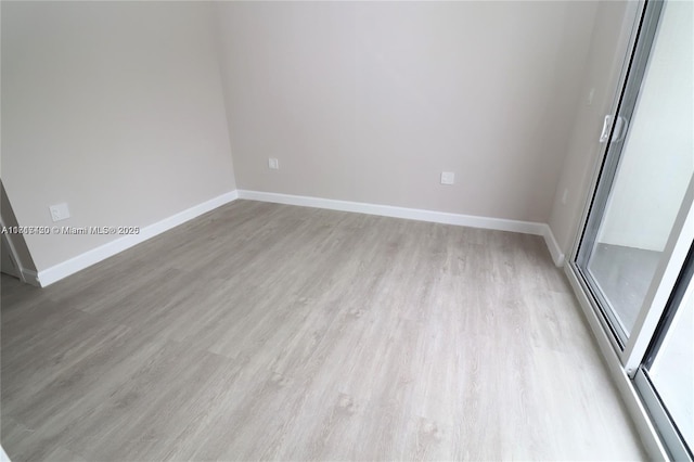 spare room featuring light hardwood / wood-style flooring