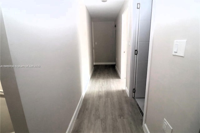 corridor with dark hardwood / wood-style flooring