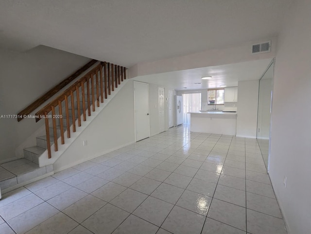 unfurnished living room featuring light tile patterned floors