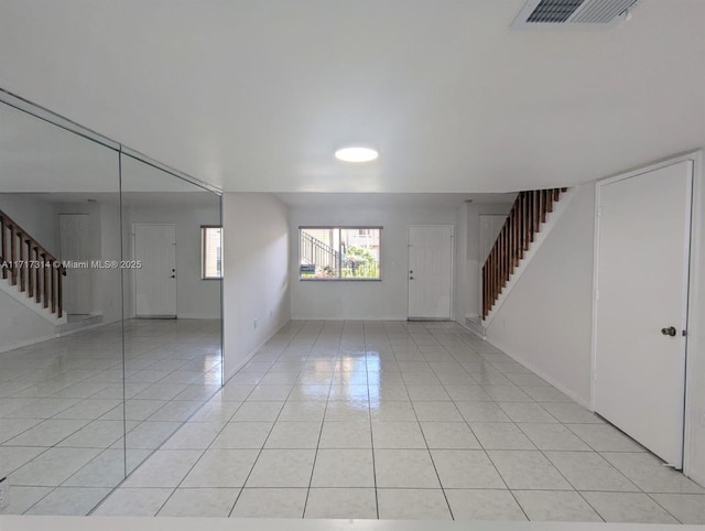 unfurnished room featuring light tile patterned floors