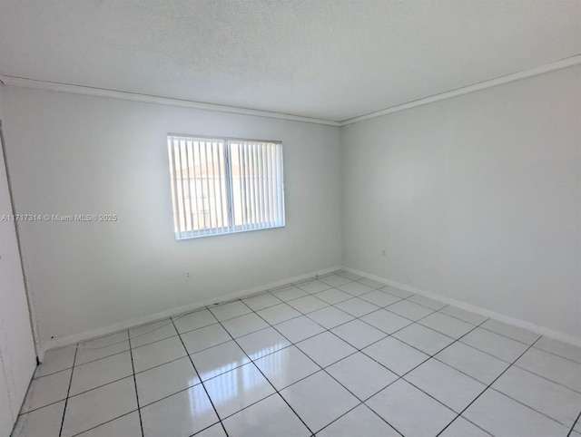 spare room with a textured ceiling and ornamental molding