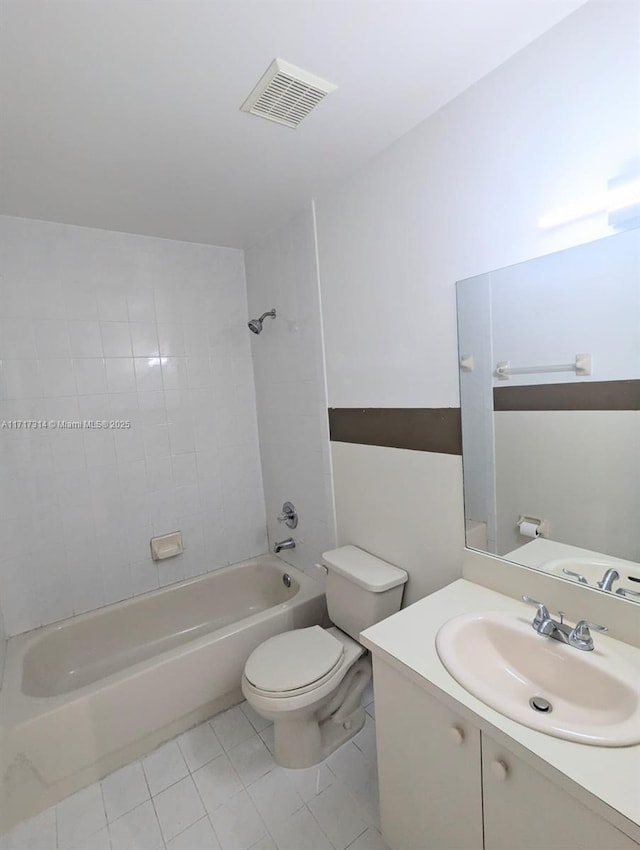 full bathroom with tile patterned floors, toilet, vanity, and tiled shower / bath