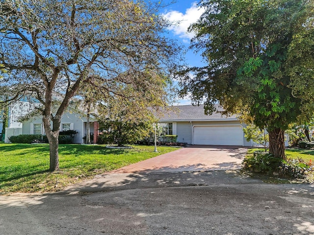 view of front facade with a garage and a front lawn