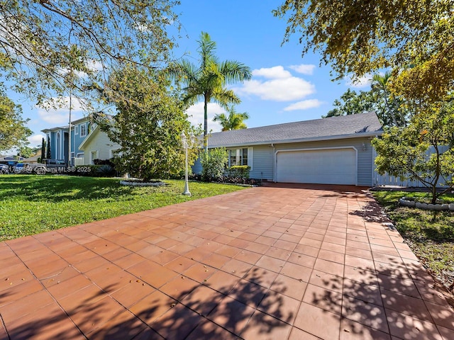 view of front of property featuring a garage and a front yard