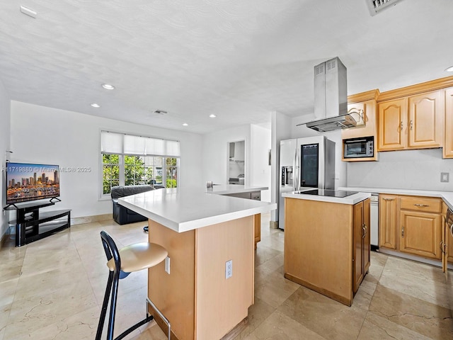 kitchen featuring island range hood, a kitchen bar, a kitchen island, and black appliances