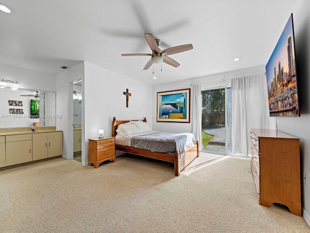 carpeted bedroom with access to exterior, ceiling fan, and ensuite bathroom