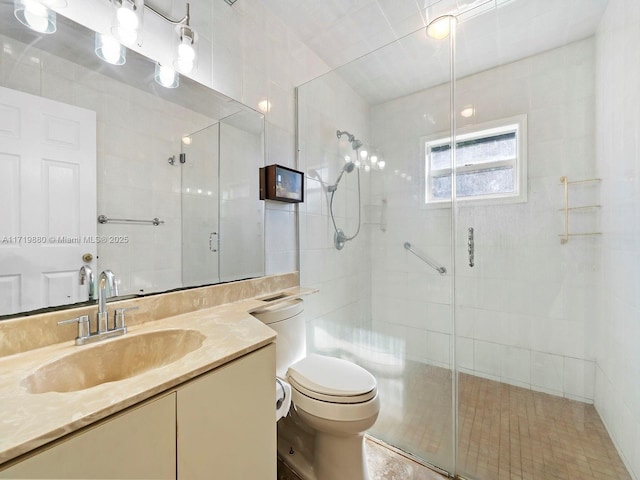 bathroom featuring vanity, toilet, and an enclosed shower