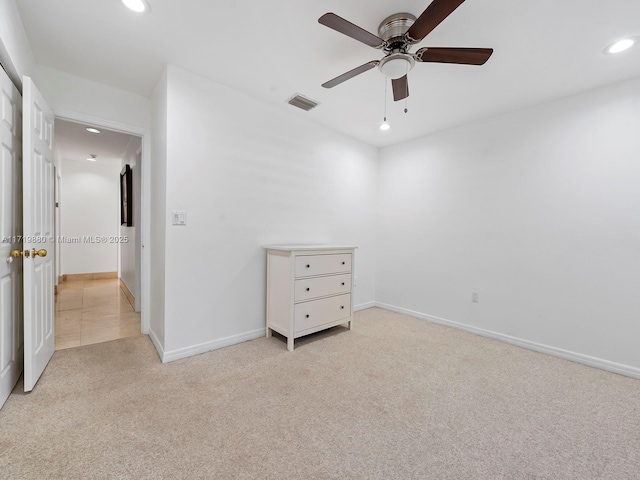 unfurnished bedroom featuring ceiling fan and light carpet