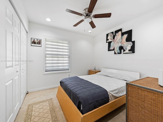 carpeted bedroom featuring ceiling fan and a closet