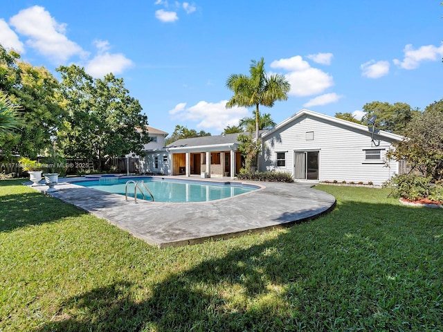 view of swimming pool with a lawn and a patio