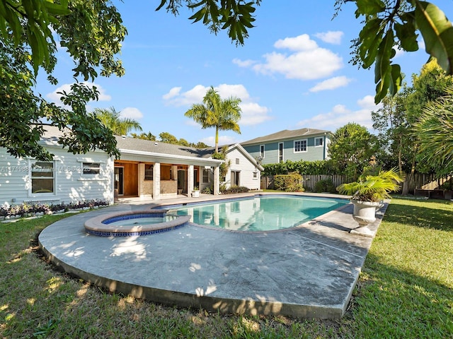 view of swimming pool featuring an in ground hot tub and a lawn