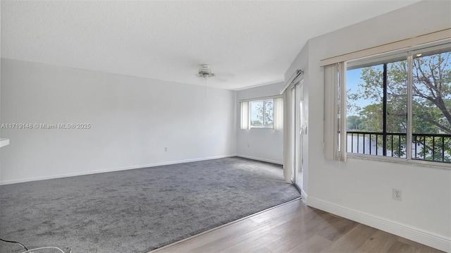 carpeted empty room featuring a water view and a textured ceiling