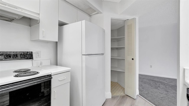 kitchen with electric range, white fridge, a textured ceiling, white cabinets, and light wood-type flooring