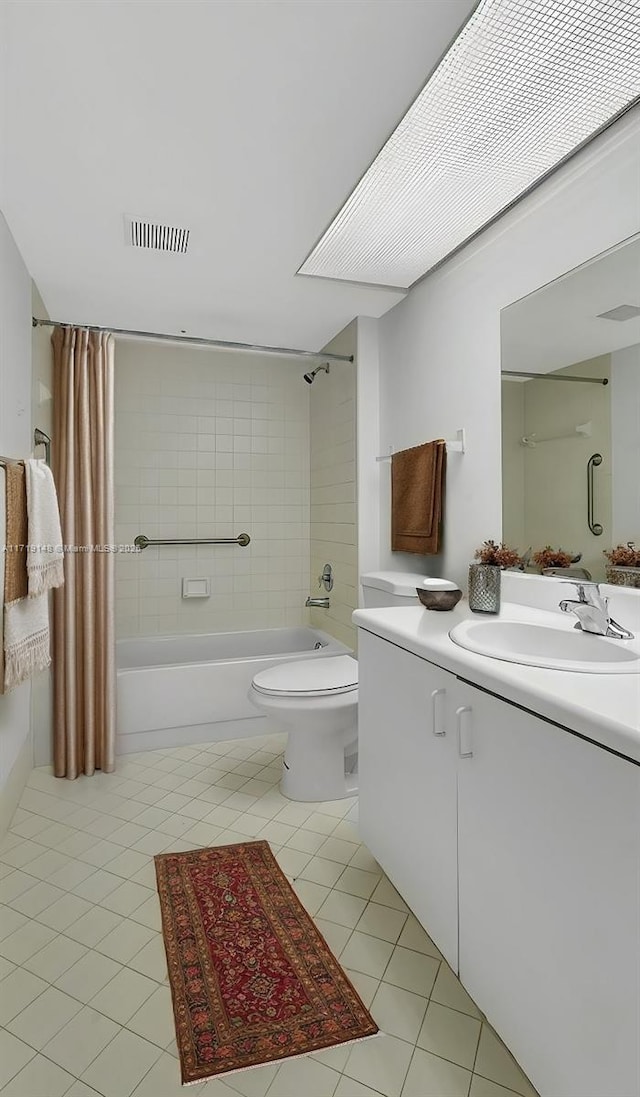 full bathroom featuring tile patterned flooring, shower / tub combo, vanity, and toilet