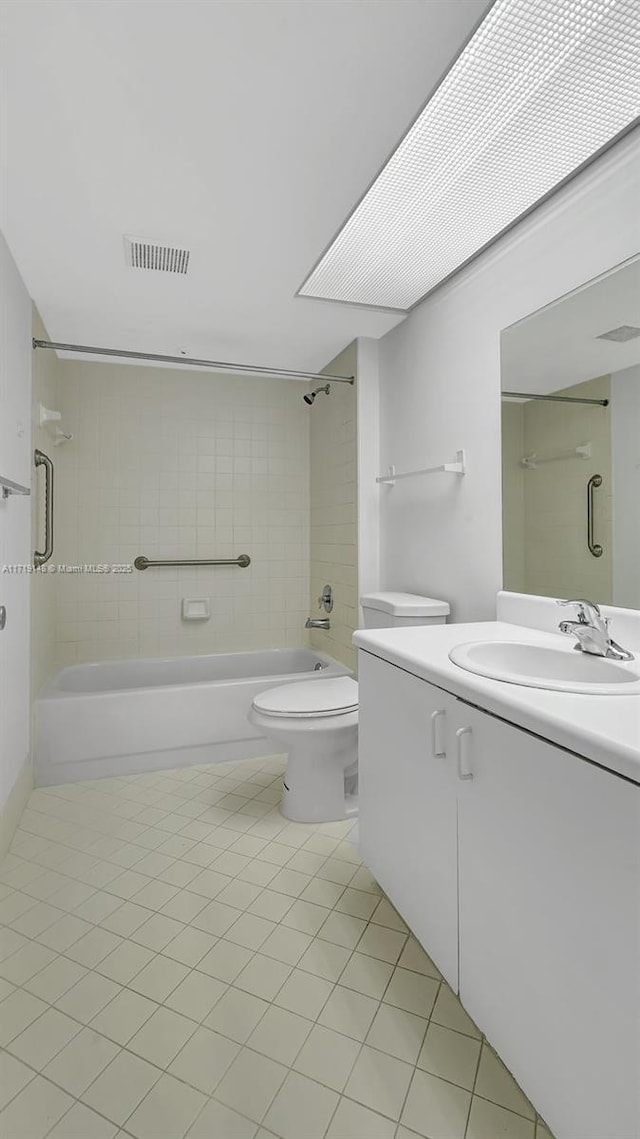 full bathroom featuring tile patterned floors, vanity, toilet, and tiled shower / bath combo