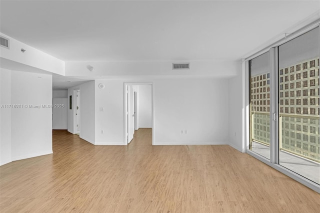 spare room featuring light hardwood / wood-style floors