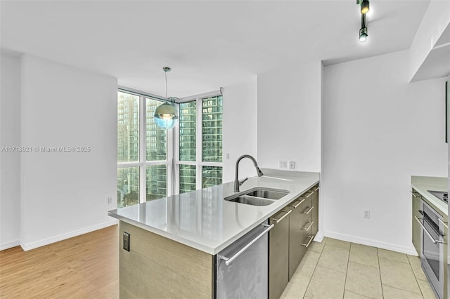 kitchen featuring kitchen peninsula, expansive windows, stainless steel appliances, sink, and pendant lighting