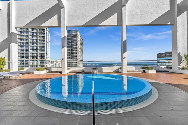 view of pool with a water view