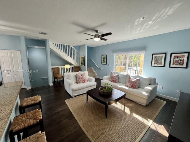 living room featuring dark hardwood / wood-style floors and ceiling fan