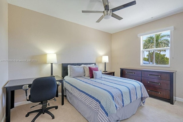 bedroom with ceiling fan and light carpet