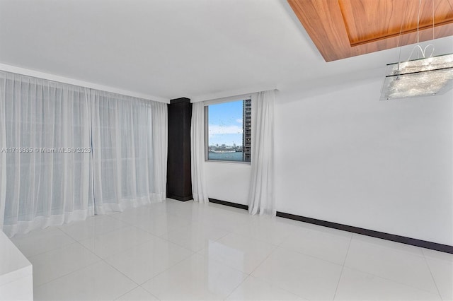 spare room featuring light tile patterned flooring