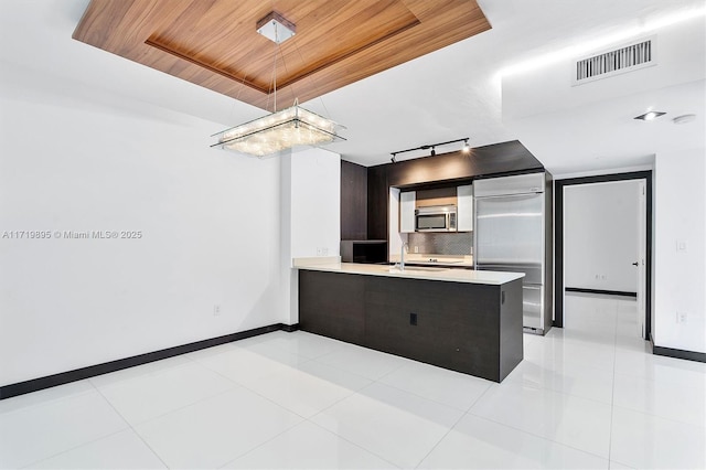 kitchen with backsplash, kitchen peninsula, sink, appliances with stainless steel finishes, and wood ceiling