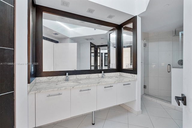 bathroom featuring tile patterned floors, vanity, and an enclosed shower