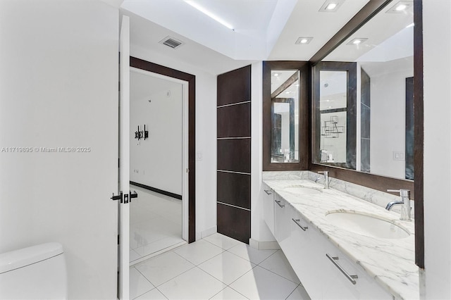 bathroom featuring tile patterned flooring, vanity, and toilet